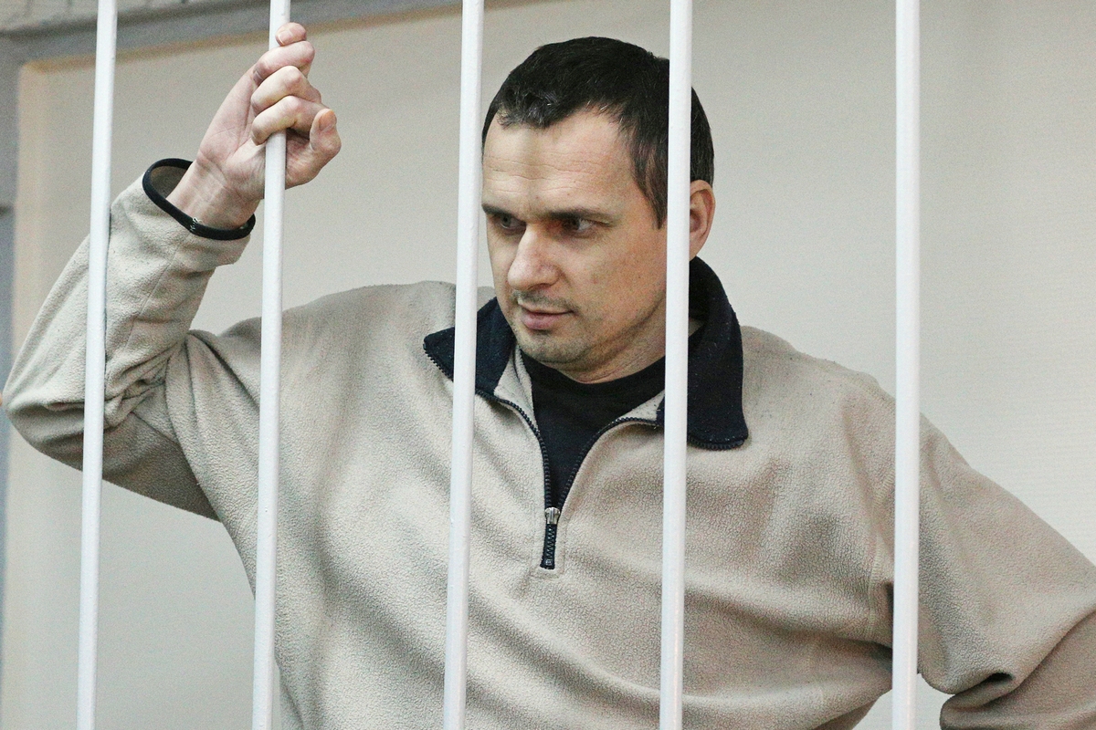 Ukrainian film director Oleg Sentsov (right), was arrested on charges of terrorism last year in Crimea shortly after Russia seized it from Ukraine. He's shown here at a hearing at Moscow's Lefortovo District Court on Dec. 26, 2014.